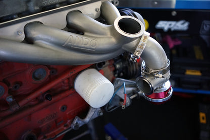 Cast stainless wastegate relocation elbow fitted to turbo manifold showing external wastegate orientation