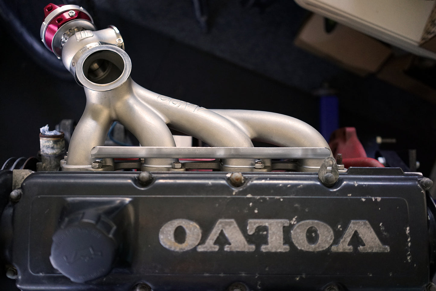 Ando Engineering Volvo Redblock 8-valve turbo manifold installed on B230 engine showing fitment and turbo manifold design